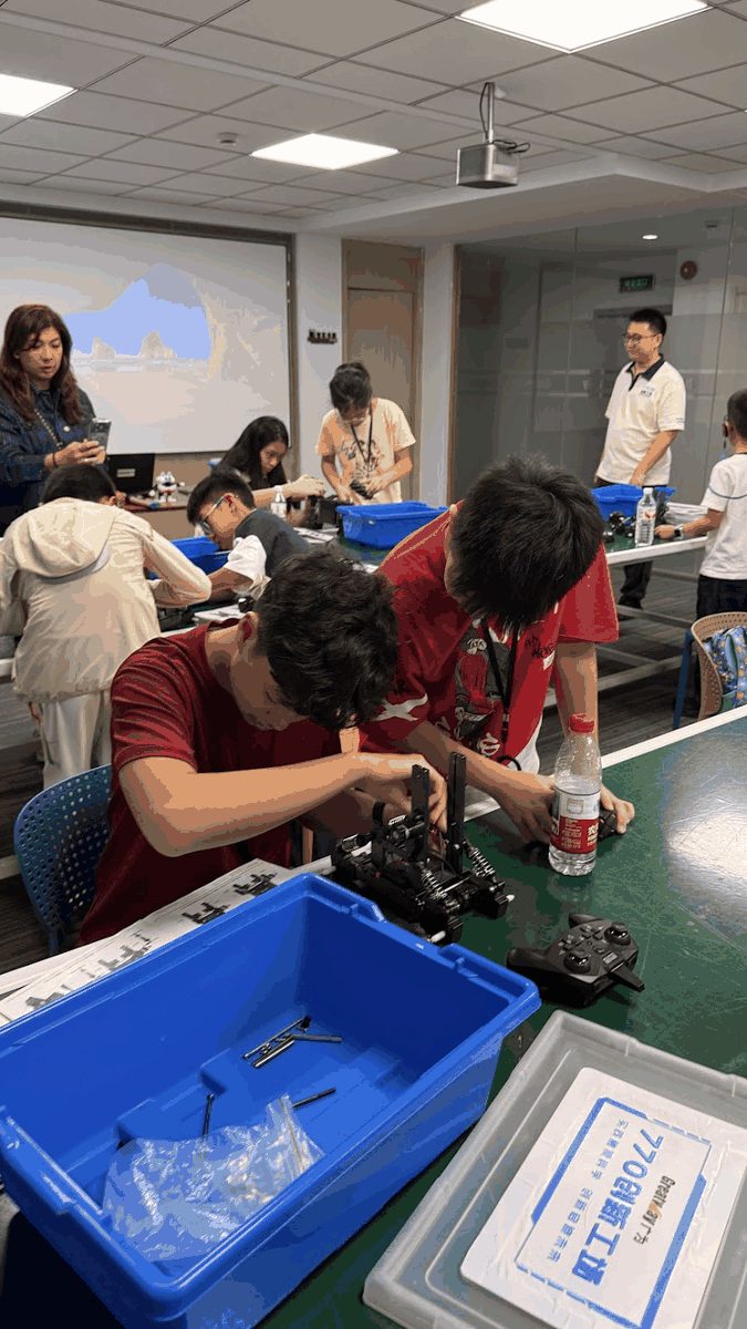 Students assembling a robot model in groups